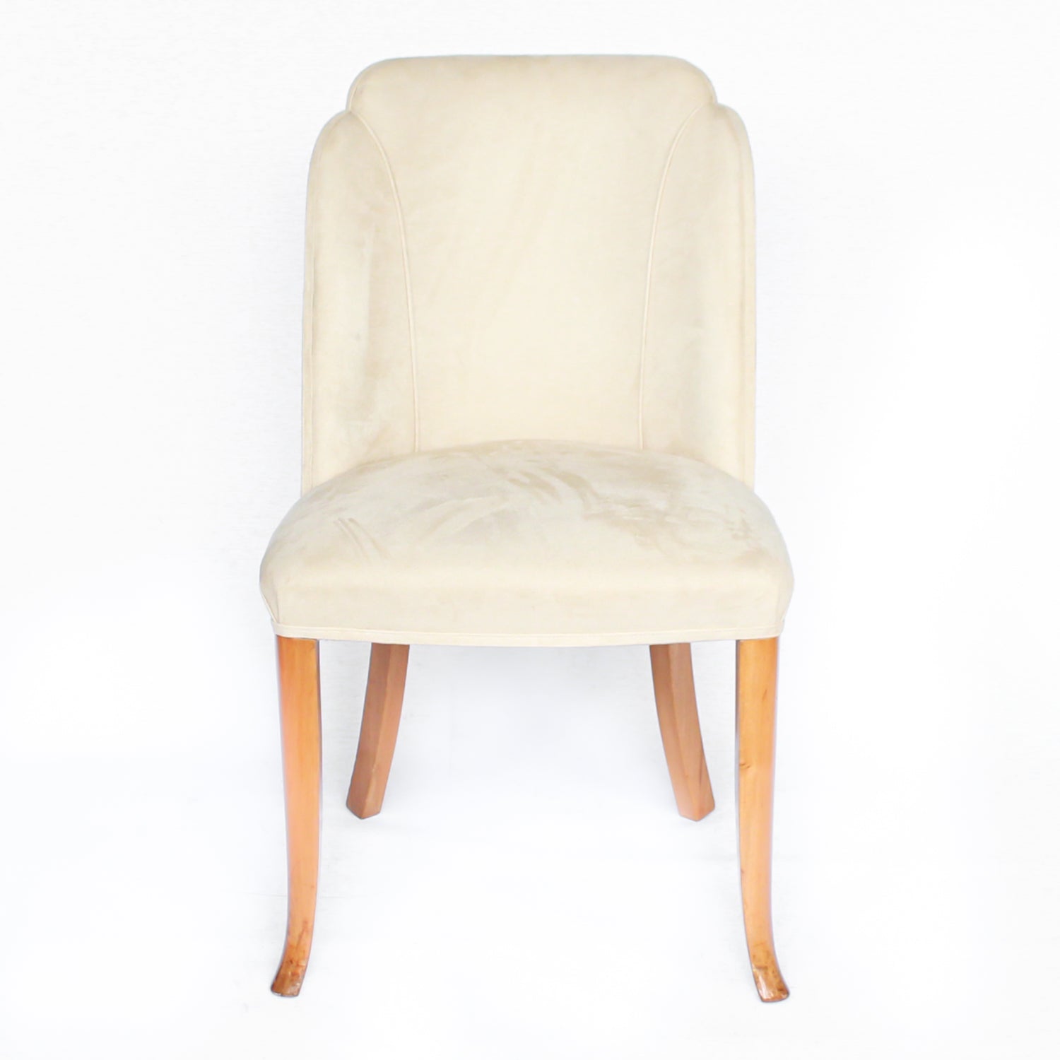 An Art Deco dining table and six chairs. Serpentine edged, burr walnut table set over pedestal legs in straight grain walnut with burr walnut reeded detail. Cloud back chairs upholstered in cream leather.