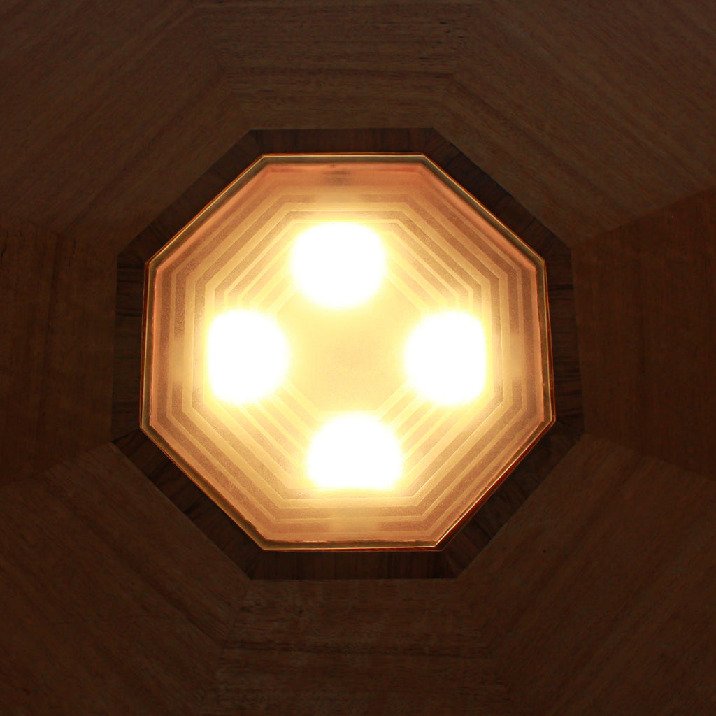 An Art Deco, octagonal dining/centre table in walnut and satin wood veneer with original light in the centre.