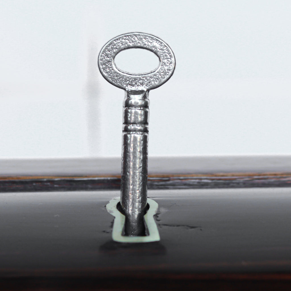 An Art Deco serving/drinks trolley with mirrored top. Double ice-box to one side with drinks cabinet to opposite side, including lower compartment for glasses. Macassar ebony throughout with walnut banding. Original chrome handle and rolling castors.