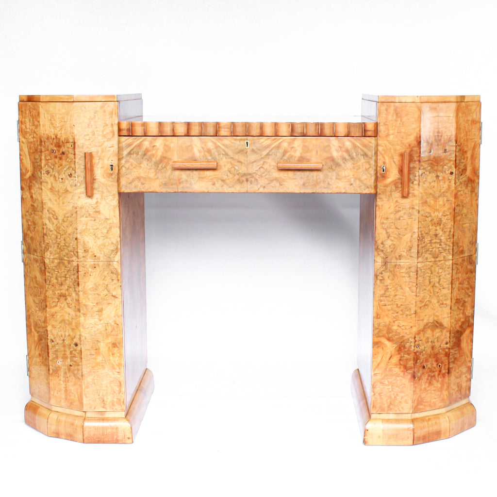 An Art Deco console sideboard by Hille. Burr walnut veneer throughout. Scallop-edged detail to front with integral drawer. Shelved cabinets to either side.