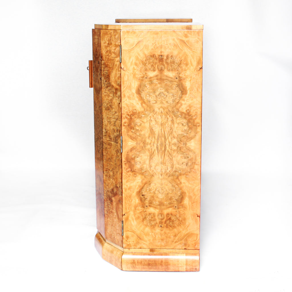 An Art Deco console sideboard by Hille. Burr walnut veneer throughout. Scallop-edged detail to front with integral drawer. Shelved cabinets to either side.