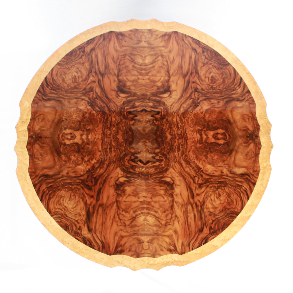 Art Deco, figured walnut veneer nest of tables. A shaped table with cross-footed base and four integral side tables. Burr and straight grain walnut throughout with birdseye maple border.