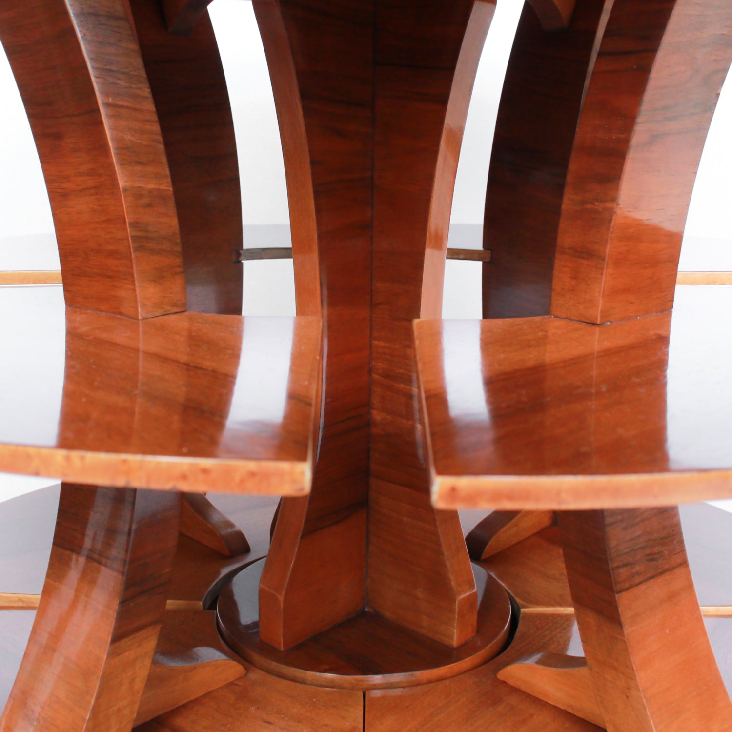 Art Deco, figured walnut veneer nest of tables. A shaped table with cross-footed base and four integral side tables. Burr and straight grain walnut throughout with birdseye maple border.