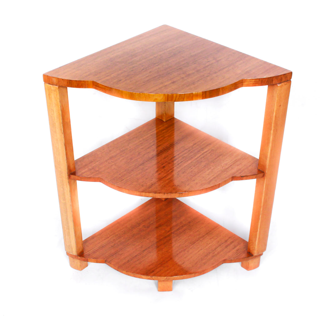 An Art Deco nest of tables in figured and straight grain walnut veneer. Main table with shaped edging set over cross footed base. Four shelved, integral side tables.