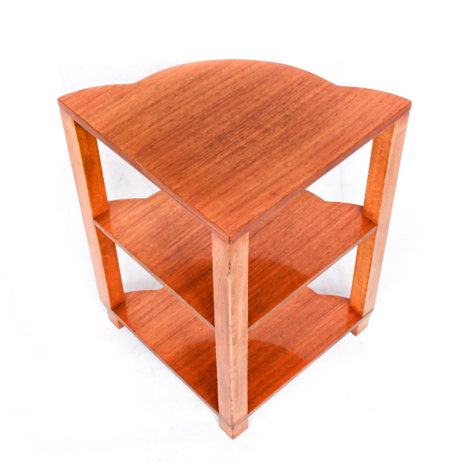 An Art Deco nest of tables in figured and straight grain walnut veneer. Main table with shaped edging set over cross footed base. Four shelved, integral side tables.