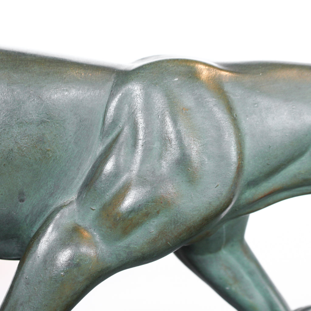 An Art Deco, patinated bronze study of a prowling lioness, mounted on a black marble base. Signed 'M. Leduc' at Jeroen Markies.