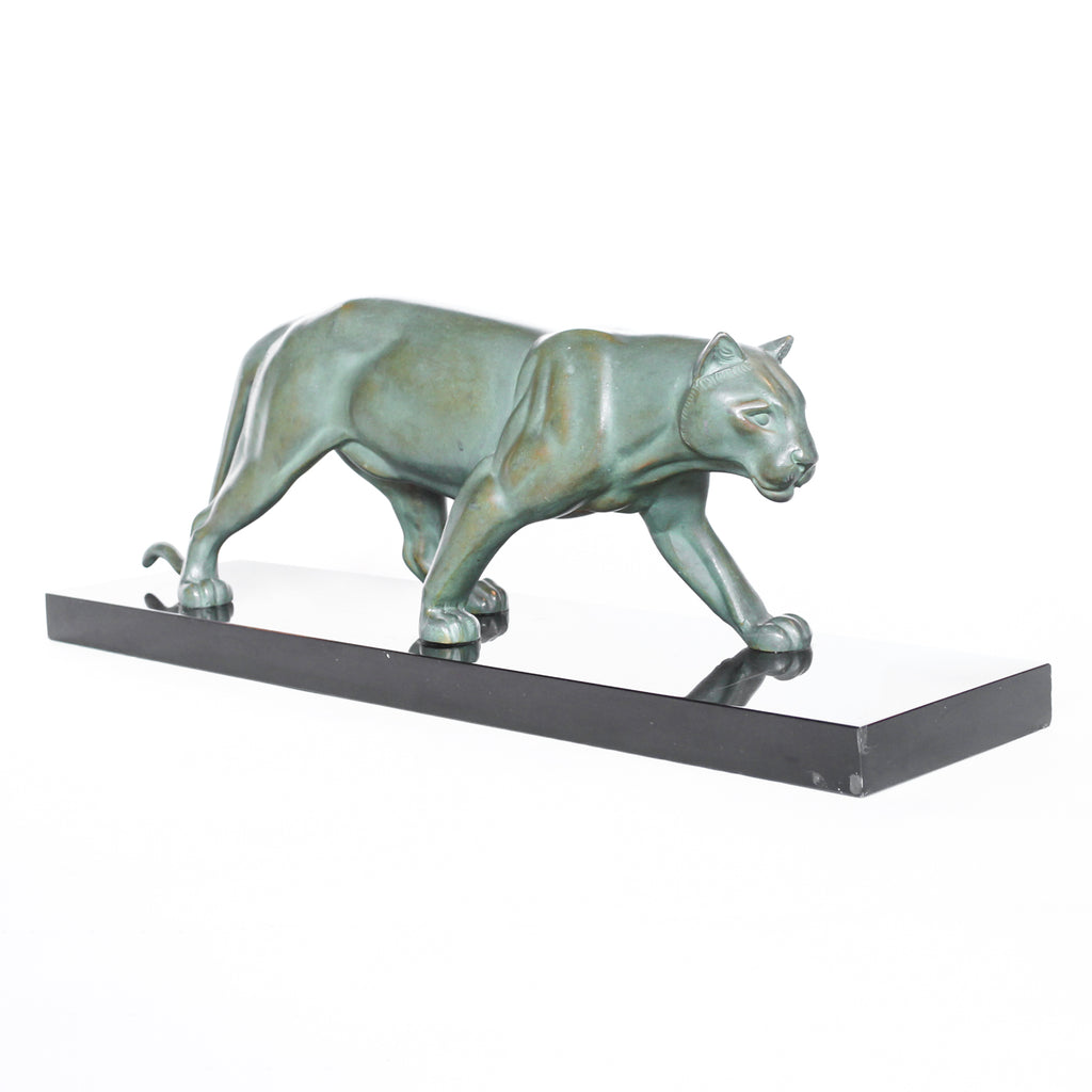 An Art Deco, patinated bronze study of a prowling lioness, mounted on a black marble base. Signed 'M. Leduc' at Jeroen Markies.