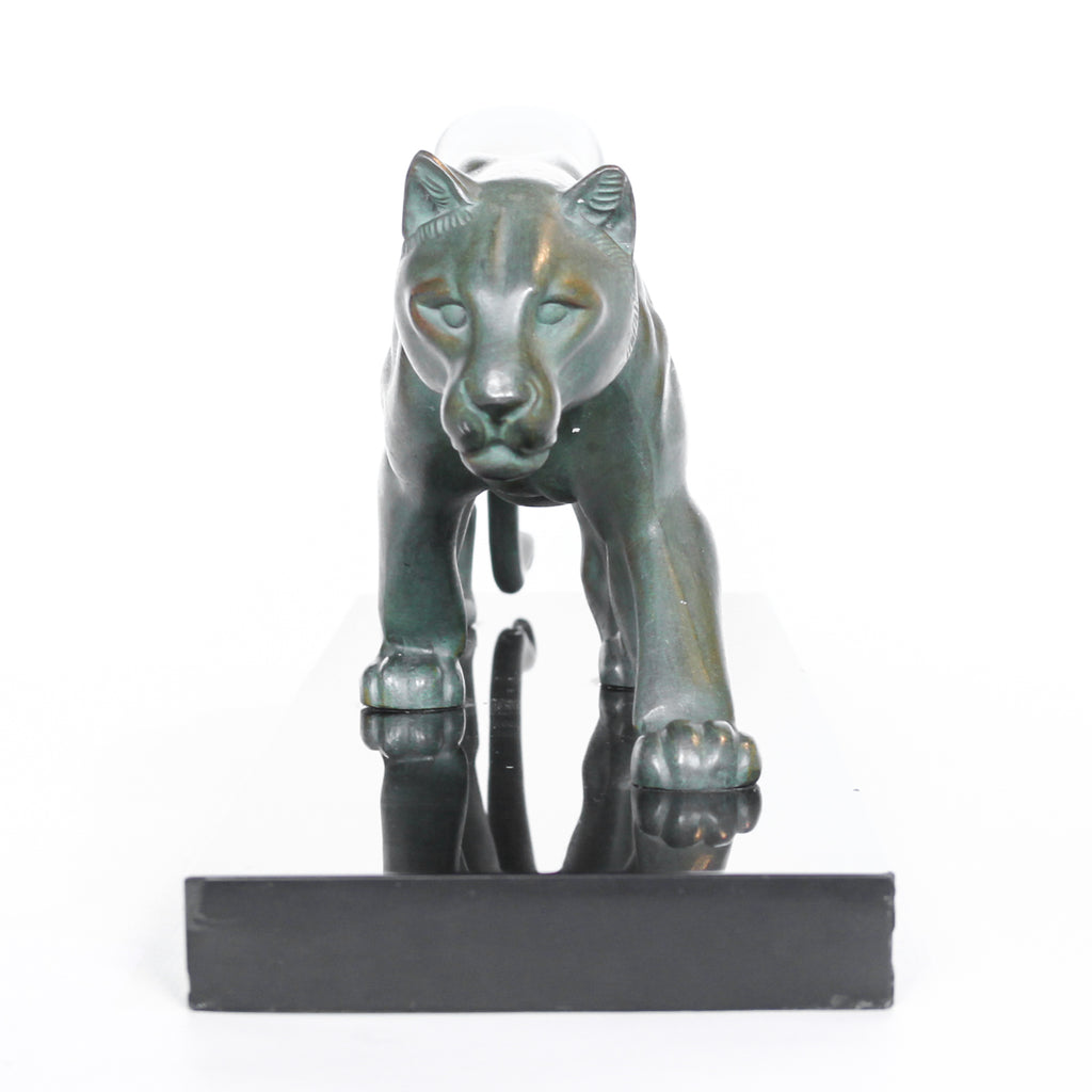 An Art Deco, patinated bronze study of a prowling lioness, mounted on a black marble base. Signed 'M. Leduc' at Jeroen Markies.