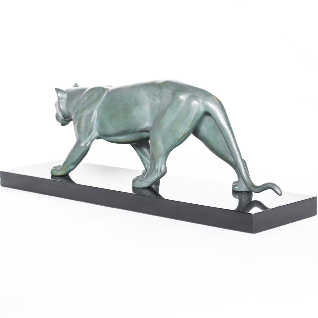 An Art Deco, patinated bronze study of a prowling lioness, mounted on a black marble base. Signed 'M. Leduc' at Jeroen Markies.