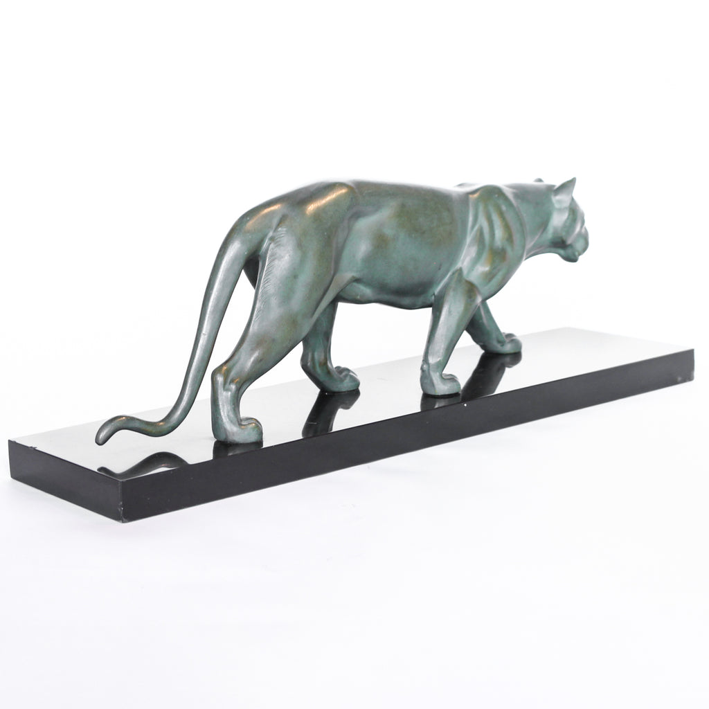An Art Deco, patinated bronze study of a prowling lioness, mounted on a black marble base. Signed 'M. Leduc' at Jeroen Markies.
