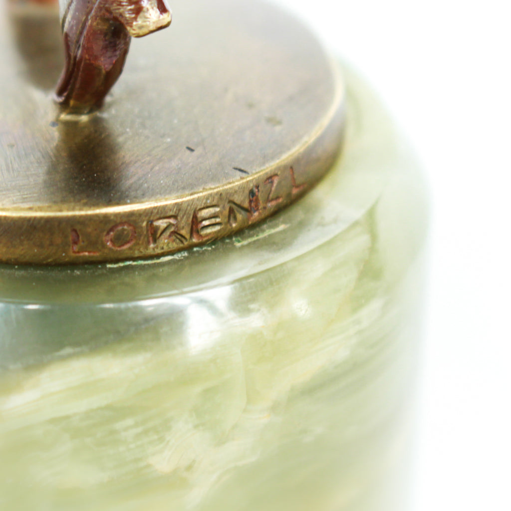 An Art Deco, cold painted bronze figure of an elegant dancer in a striking pose, raised on a green onyx base.  Signed Lorenzl to bronze