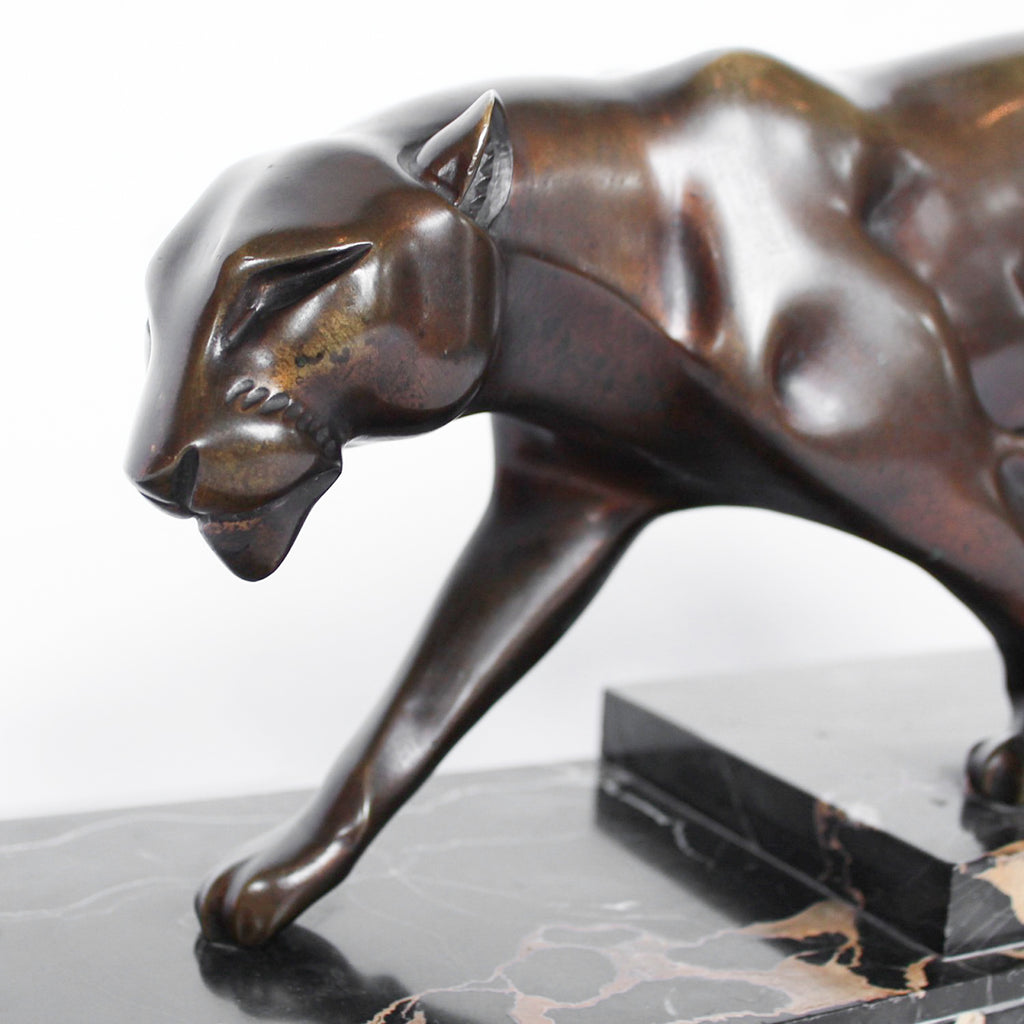 An Art Deco, patinated bronze study of a prowling panther, set over an integral marble base. Signed H Molins to marble and cast and stamped with foundry mark to cast at Jeroen Markies