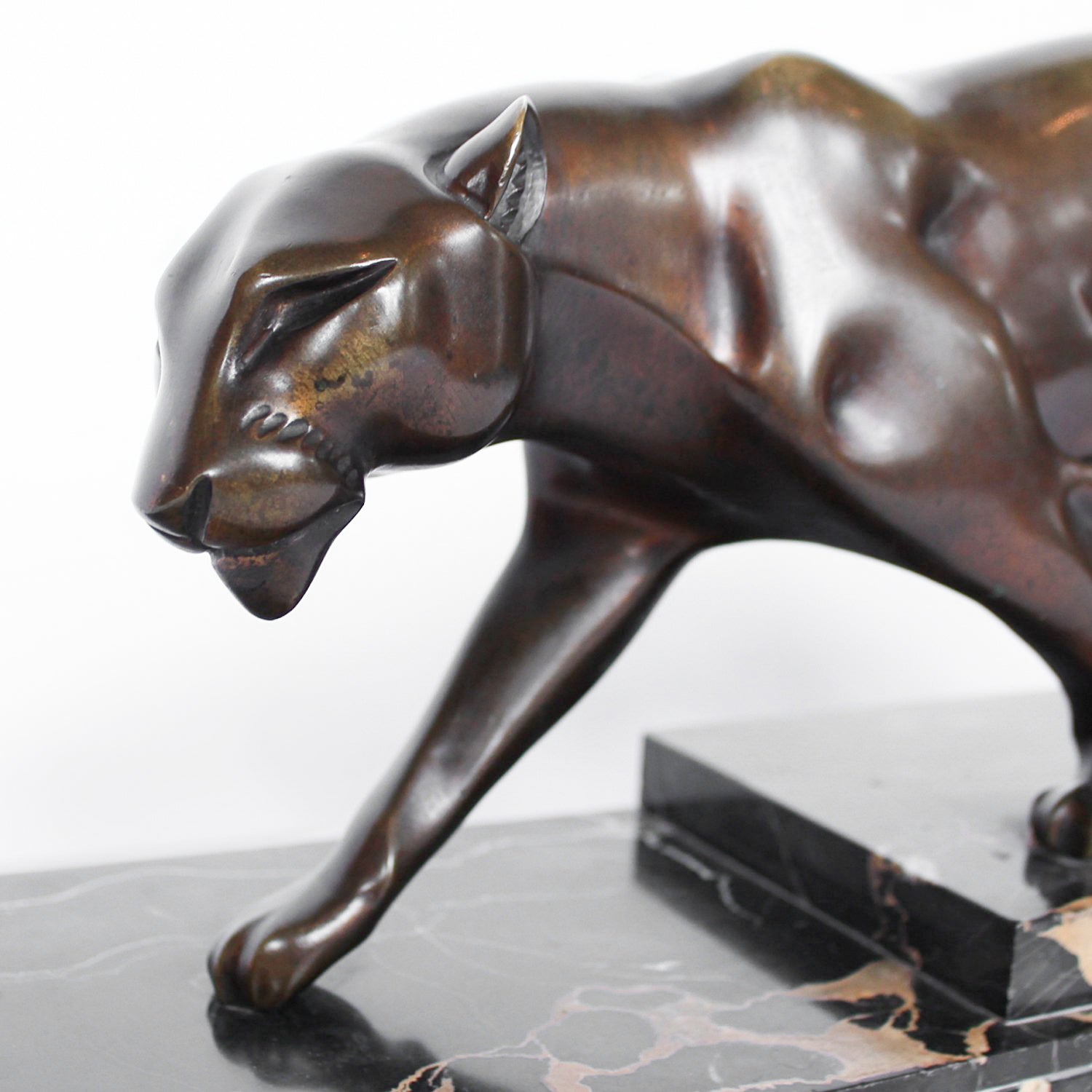 An Art Deco, patinated bronze study of a prowling panther, set over an integral marble base. Signed H Molins to marble and cast and stamped with foundry mark to cast at Jeroen Markies