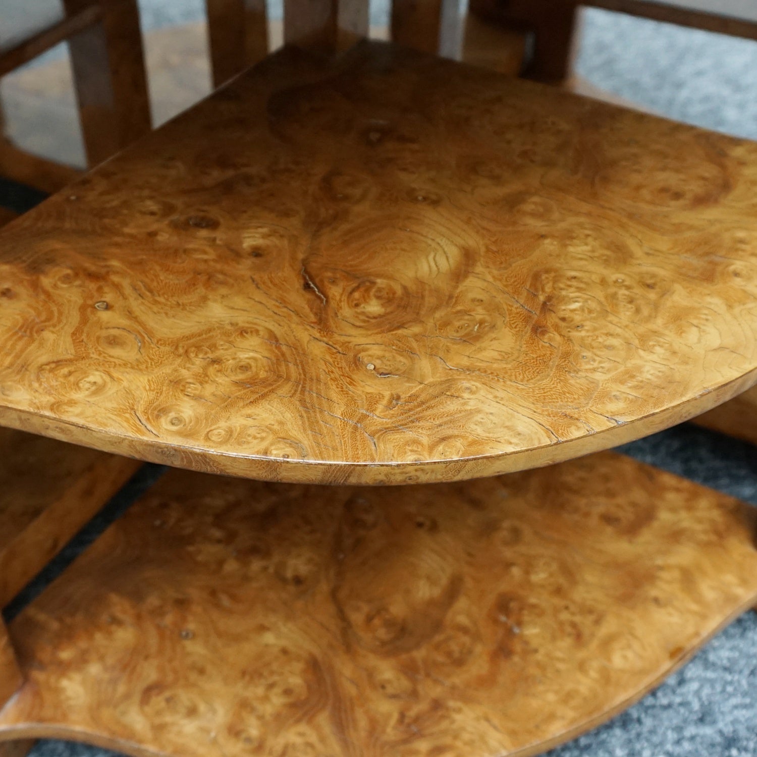 An Art Deco nest of tables by Harry & Lou Epstein Burr walnut veneered. Consisting of a central coffee table with four shelved pull out side tables. The tables have glass tops.
