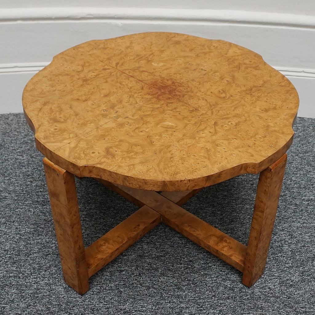 An Art Deco nest of tables by Harry & Lou Epstein Burr walnut veneered. Consisting of a central coffee table with four shelved pull out side tables. The tables have glass tops.