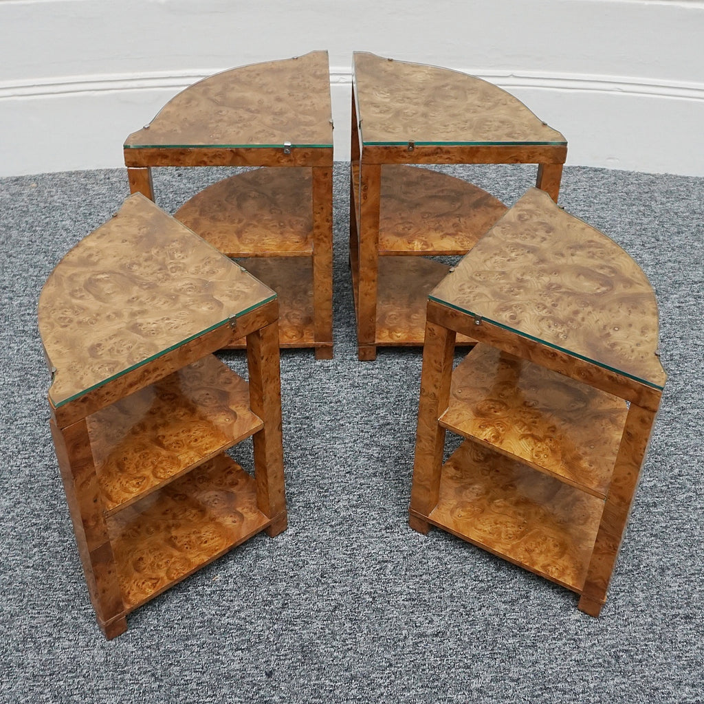 An Art Deco nest of tables by Harry & Lou Epstein Burr walnut veneered. Consisting of a central coffee table with four shelved pull out side tables. The tables have glass tops.