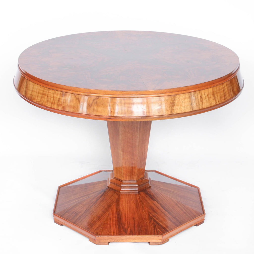 Round centre table in veneered walnut with octagonal base and central column. Table top veneered in quartered figured walnut with solid walnut edging at Jeroen Markies
