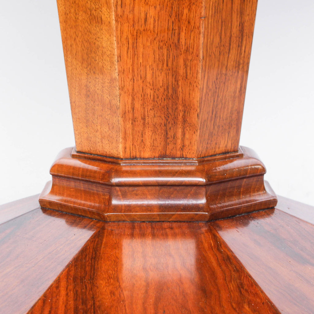 Round centre table in veneered walnut with octagonal base and central column. Table top veneered in quartered figured walnut with solid walnut edging at Jeroen Markies