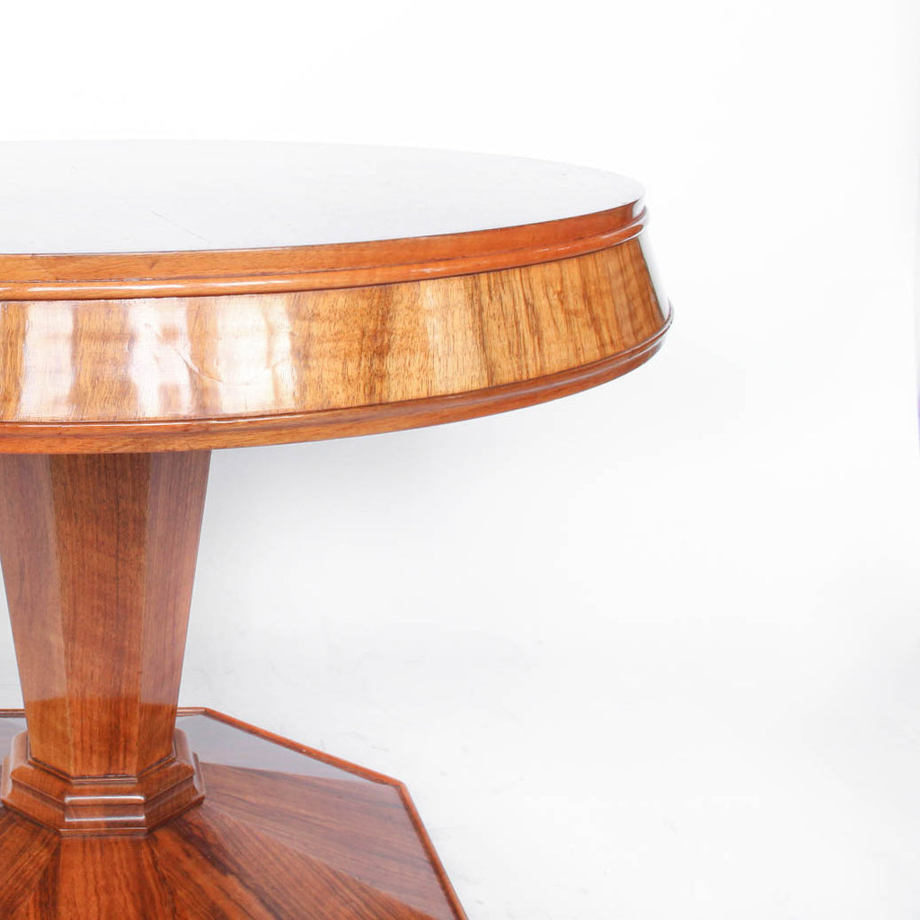 Round centre table in veneered walnut with octagonal base and central column. Table top veneered in quartered figured walnut with solid walnut edging at Jeroen Markies
