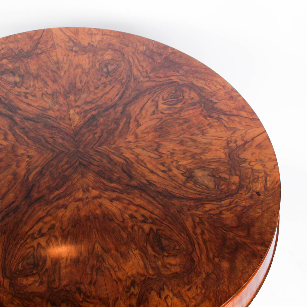 Round centre table in veneered walnut with octagonal base and central column. Table top veneered in quartered figured walnut with solid walnut edging at Jeroen Markies