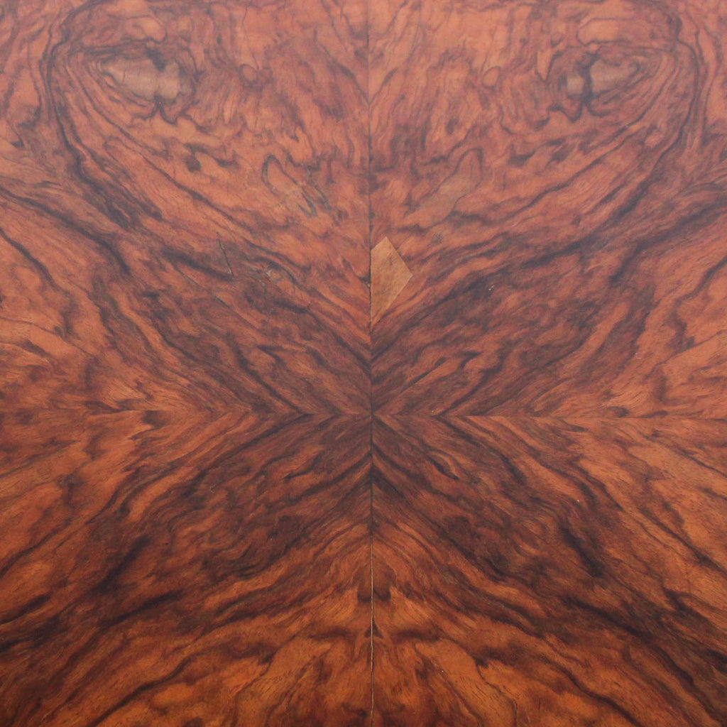 Round centre table in veneered walnut with octagonal base and central column. Table top veneered in quartered figured walnut with solid walnut edging at Jeroen Markies