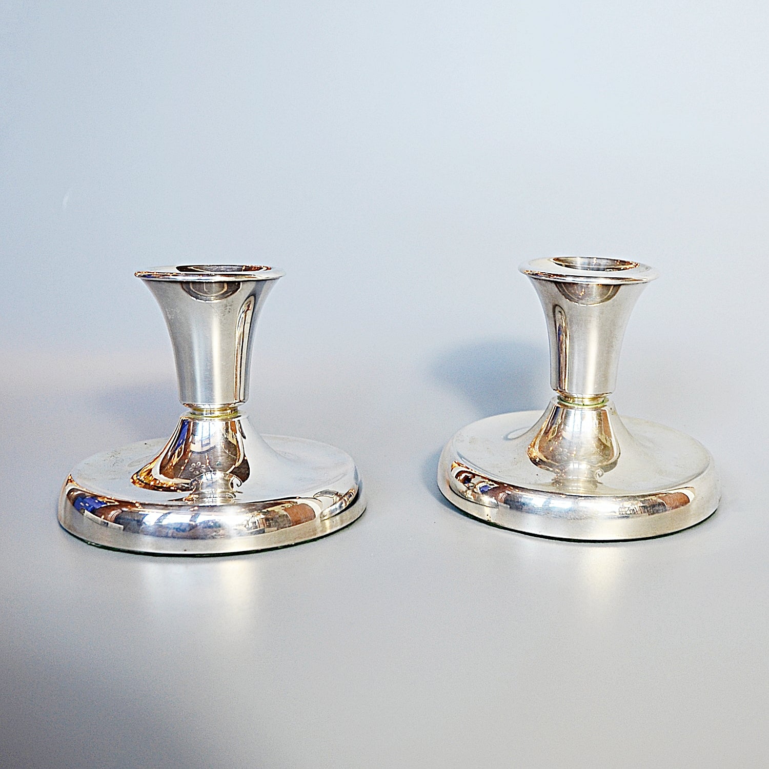 A Pair of Silver Dwarf Candlesticks