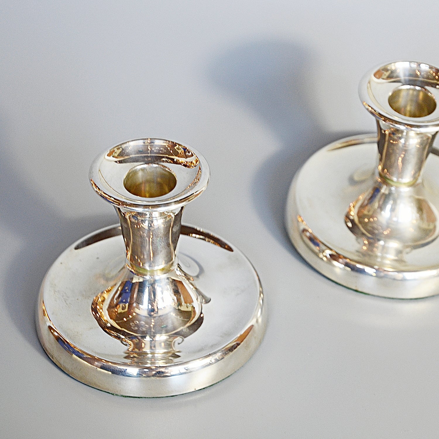 A Pair of Silver Dwarf Candlesticks