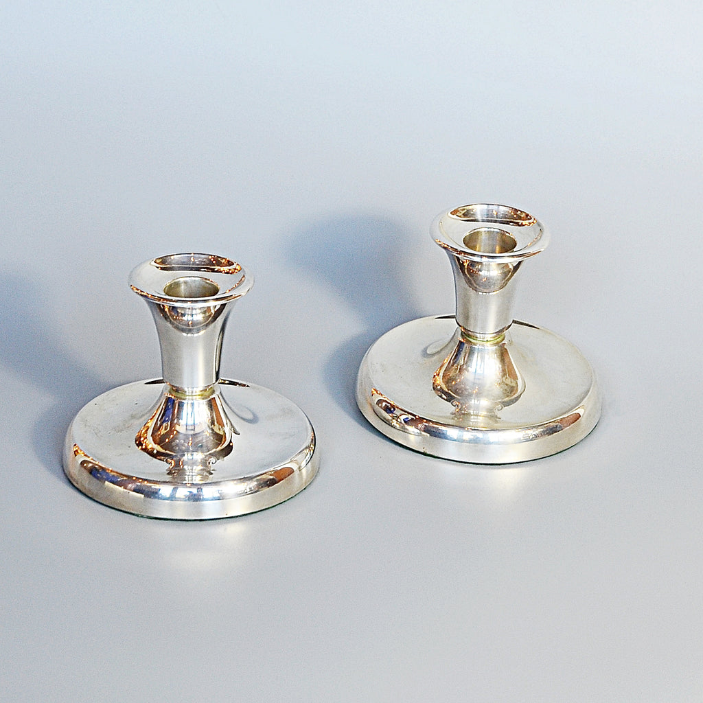 A Pair of Silver Dwarf Candlesticks