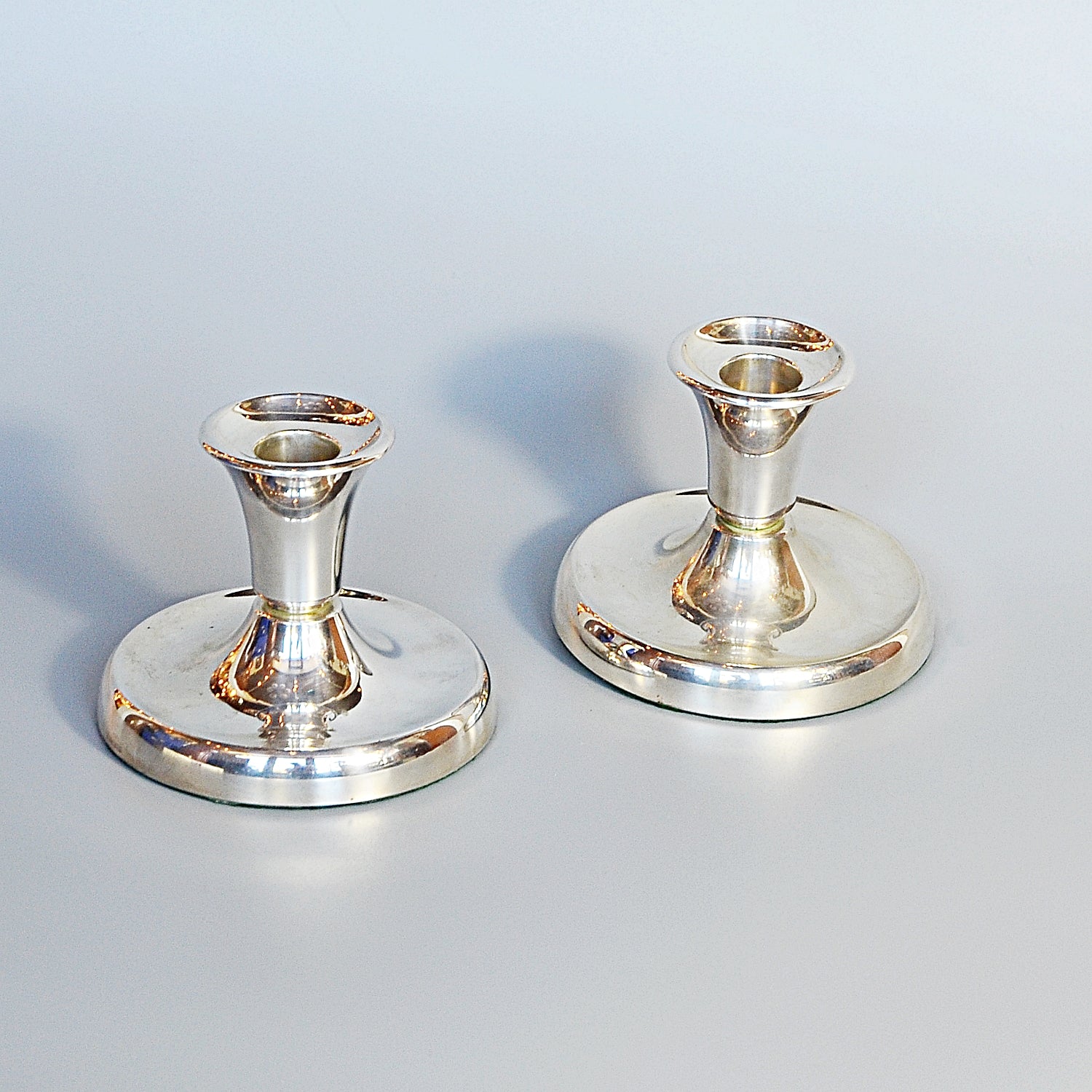 A Pair of Silver Dwarf Candlesticks