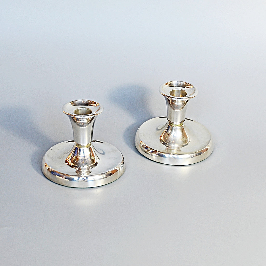 A Pair of Silver Dwarf Candlesticks