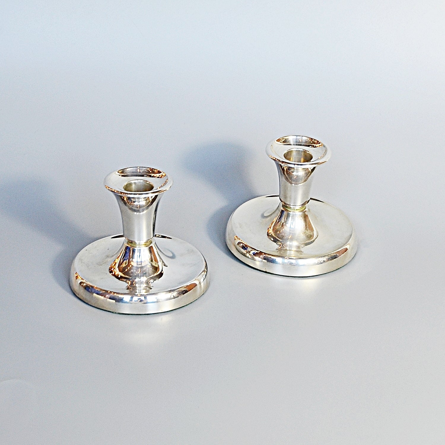 A Pair of Silver Dwarf Candlesticks