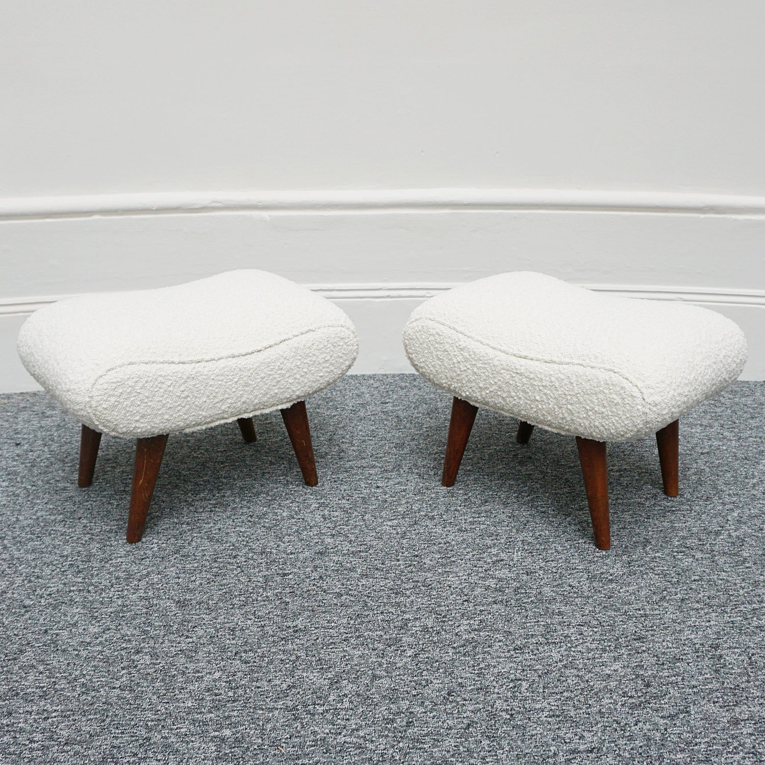  A Pair of Mid Century Footstools  re-upholstered in white Bouclé with tapered teak feet