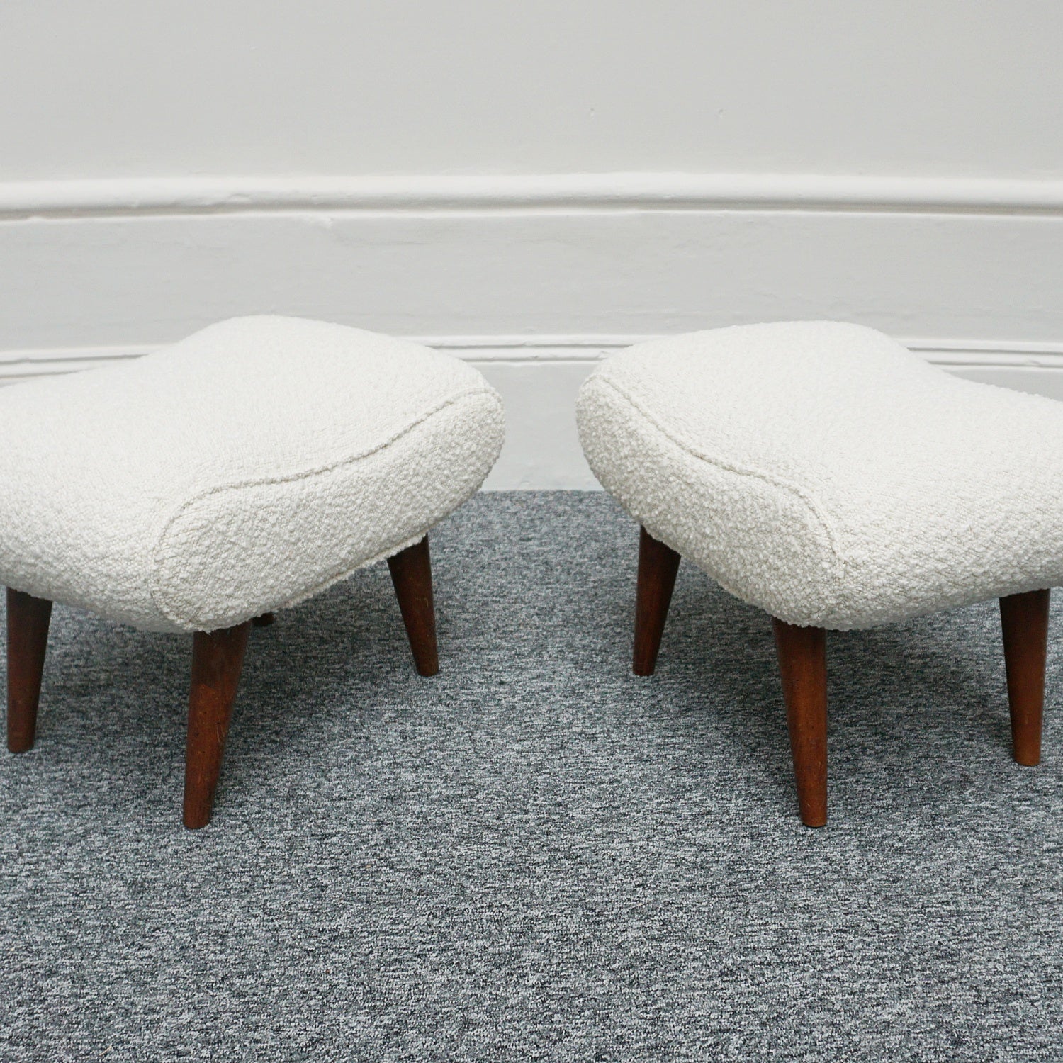 A Pair of Mid Century Footstools  re-upholstered in white Bouclé with tapered teak feet