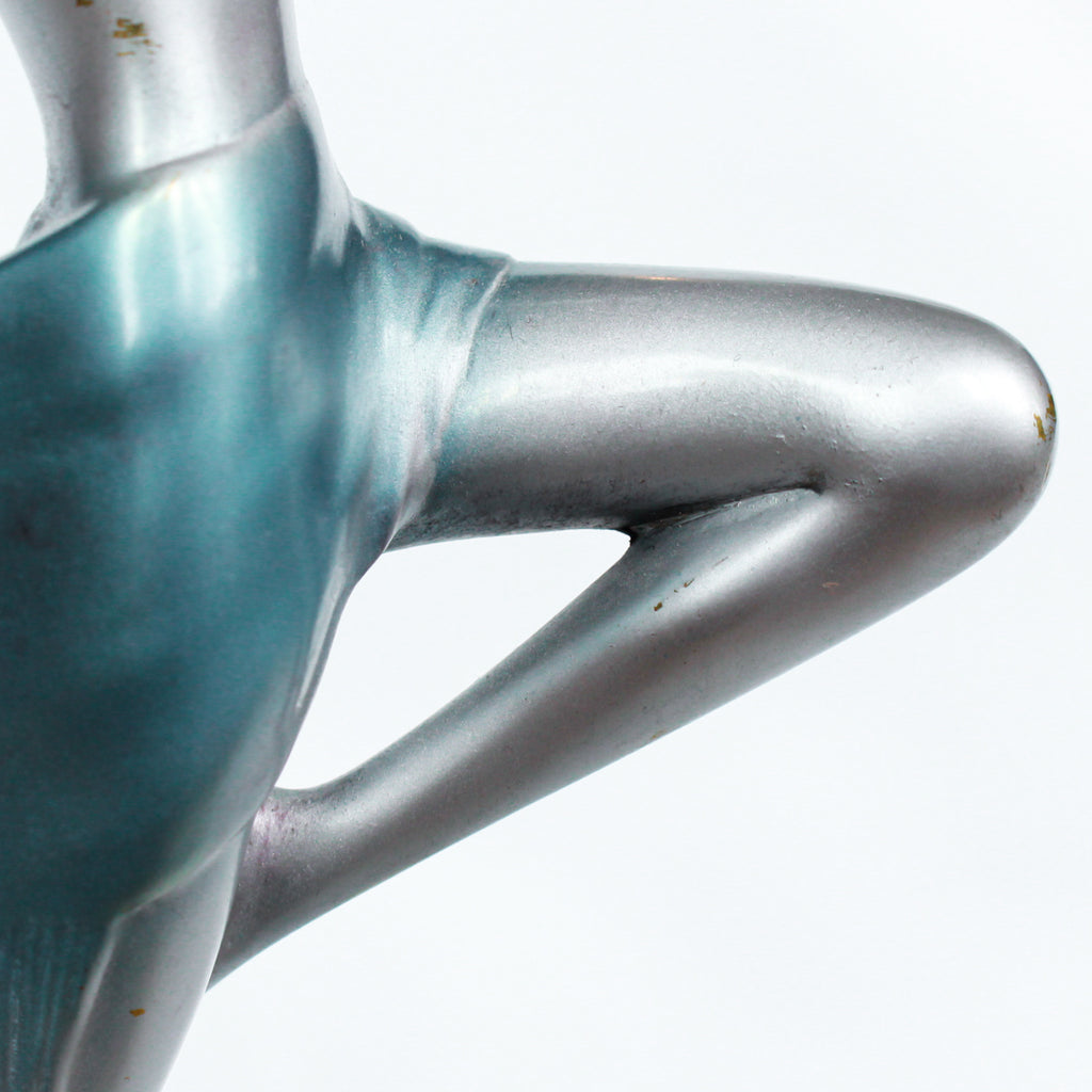 An Art Deco, cold painted bronze figure of an elegant dancer holding a tambourine, raised on a green onyx base.  Signed Lorenzl to bronze