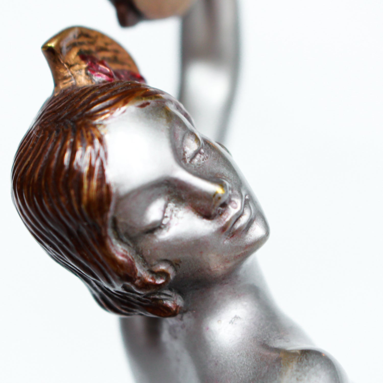 An Art Deco, cold painted bronze figure of an elegant dancer holding a tambourine, raised on a green onyx base.  Signed Lorenzl to bronze