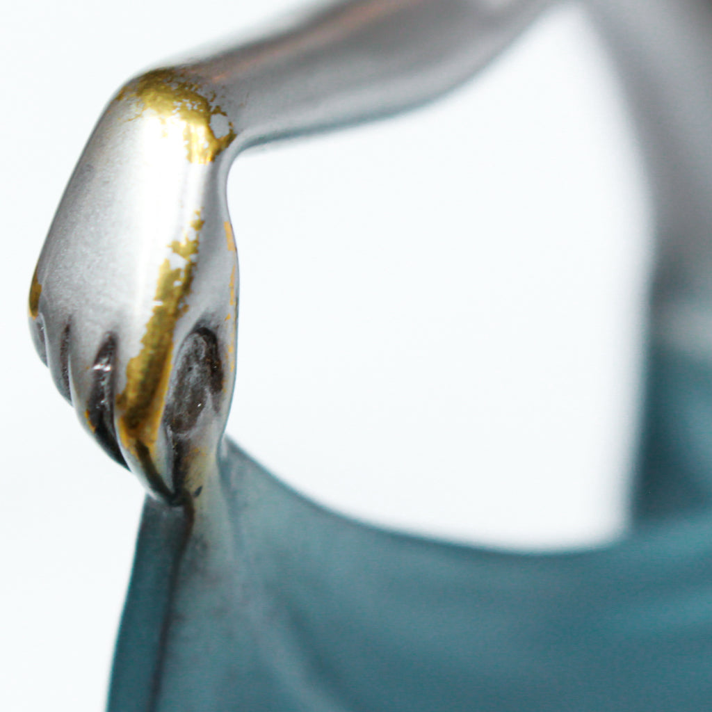 An Art Deco, cold painted bronze figure of an elegant dancer holding a tambourine, raised on a green onyx base.  Signed Lorenzl to bronze