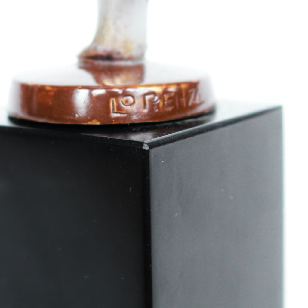 An Art Deco, cold painted bronze figure of an elegant dancer holding a tambourine, raised on a green onyx base.  Signed Lorenzl to bronze