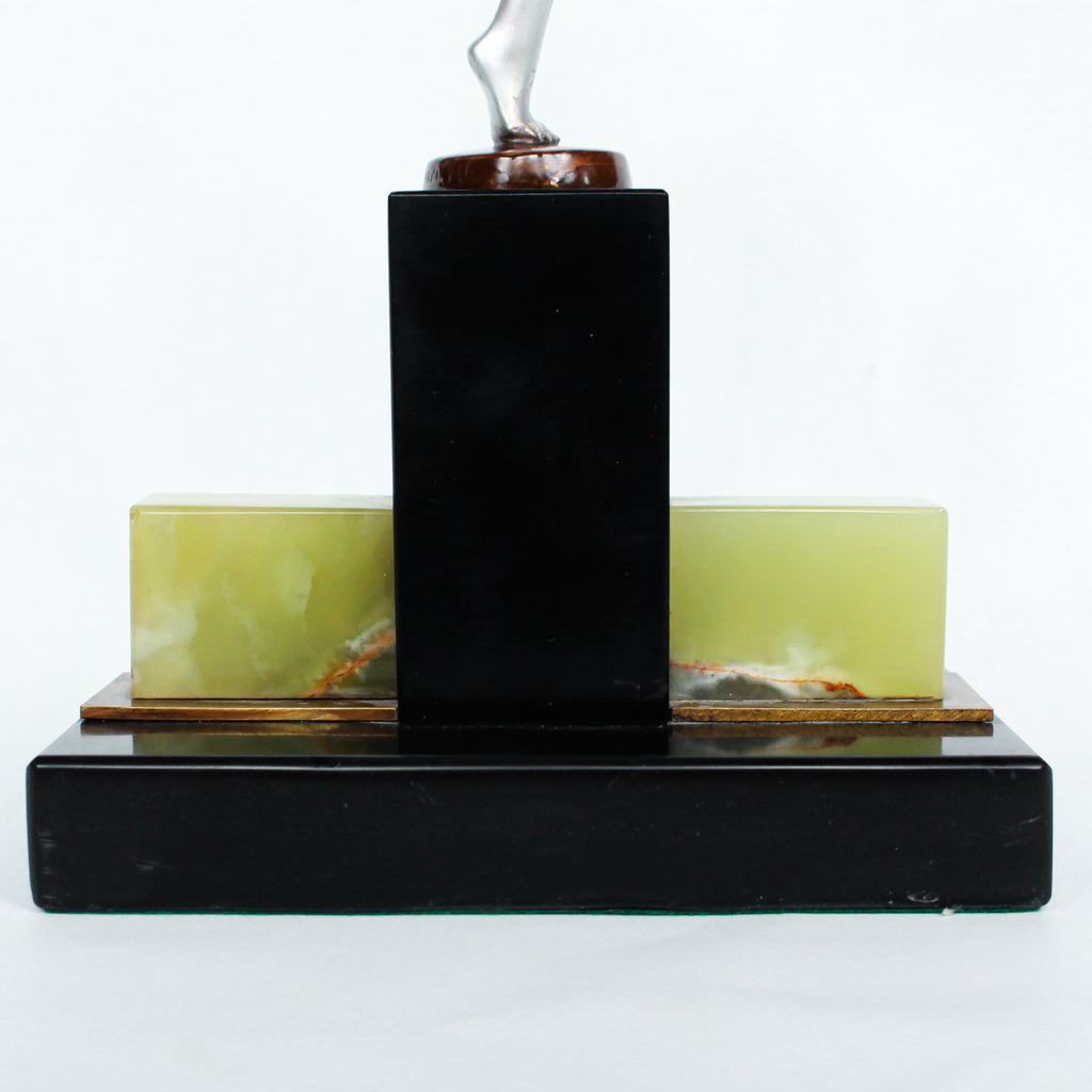 An Art Deco, cold painted bronze figure of an elegant dancer holding a tambourine, raised on a green onyx base.  Signed Lorenzl to bronze