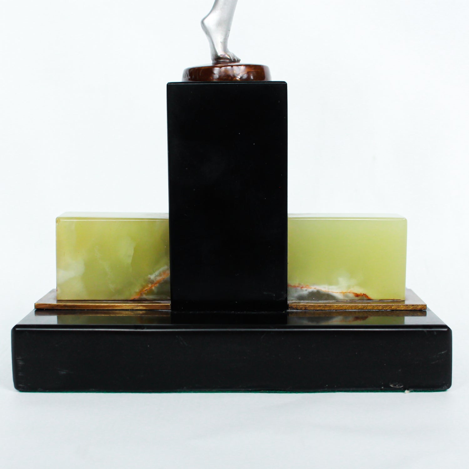 An Art Deco, cold painted bronze figure of an elegant dancer holding a tambourine, raised on a green onyx base.  Signed Lorenzl to bronze