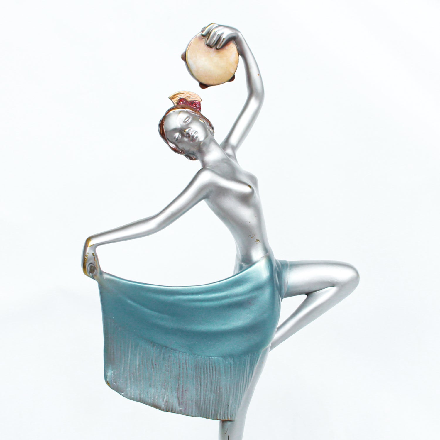 An Art Deco, cold painted bronze figure of an elegant dancer holding a tambourine, raised on a green onyx base.  Signed Lorenzl to bronze