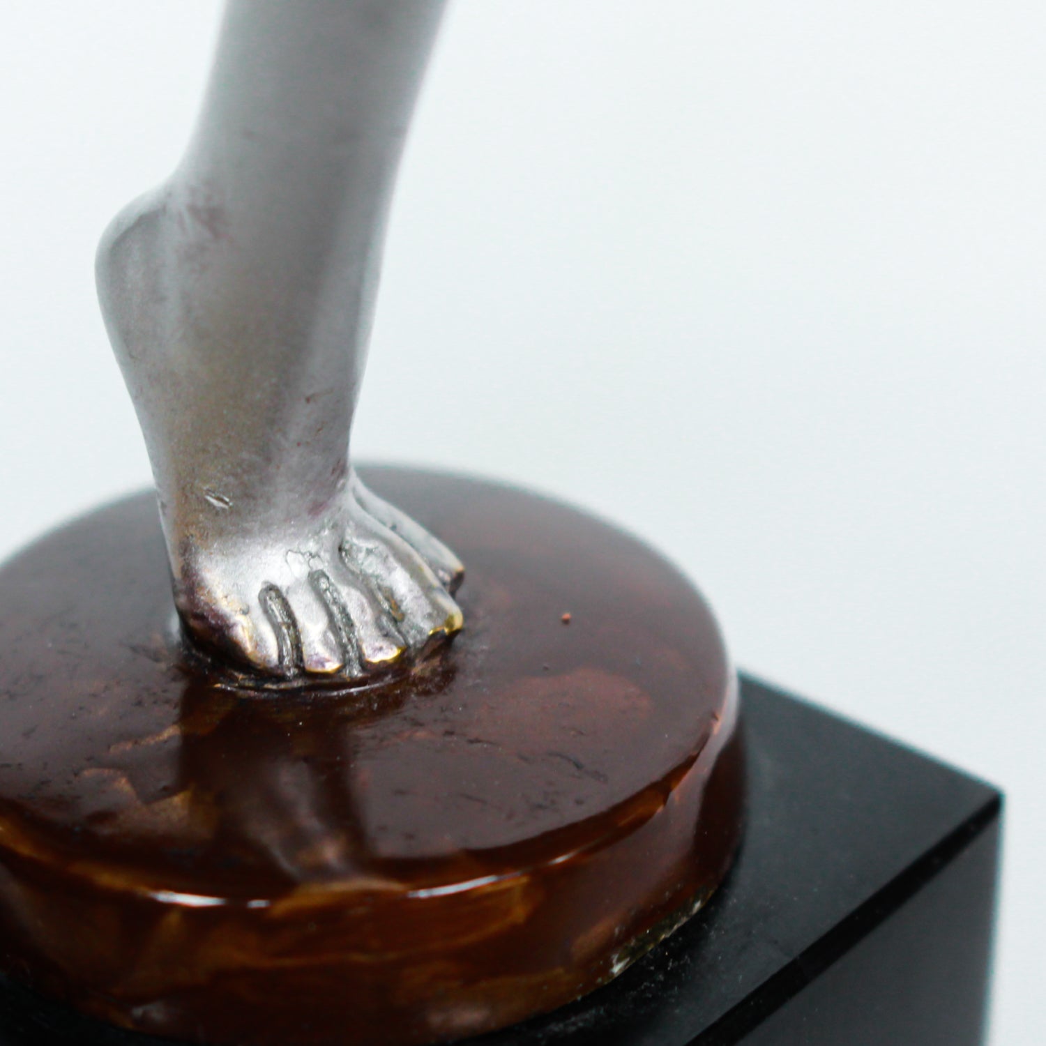 An Art Deco, cold painted bronze figure of an elegant dancer holding a tambourine, raised on a green onyx base.  Signed Lorenzl to bronze