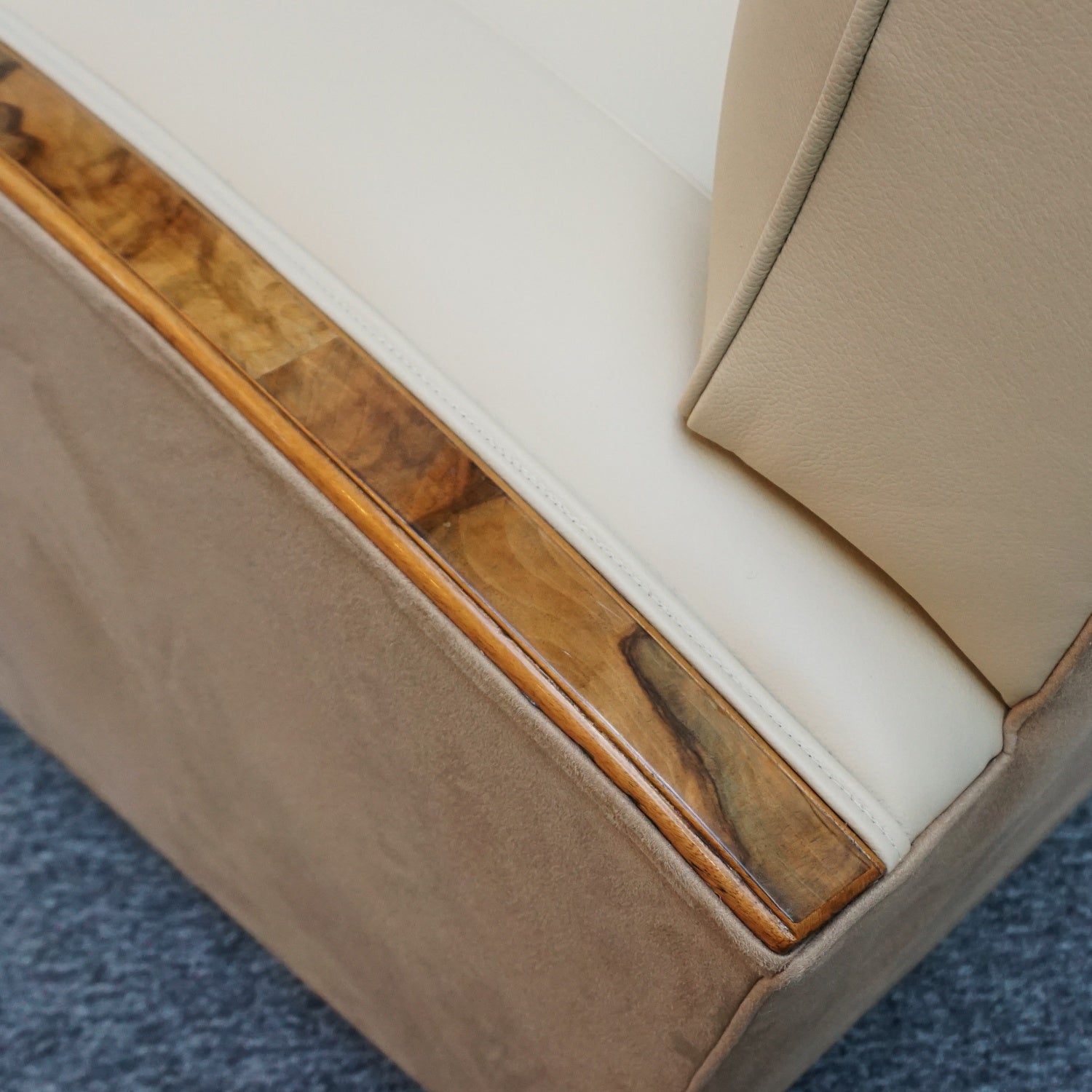 An Art Deco three piece tank suite by Heals of london. Made of Burr and solid walnut banding with reeded lower section, Upholstered in cream leather and contrasting faux suede