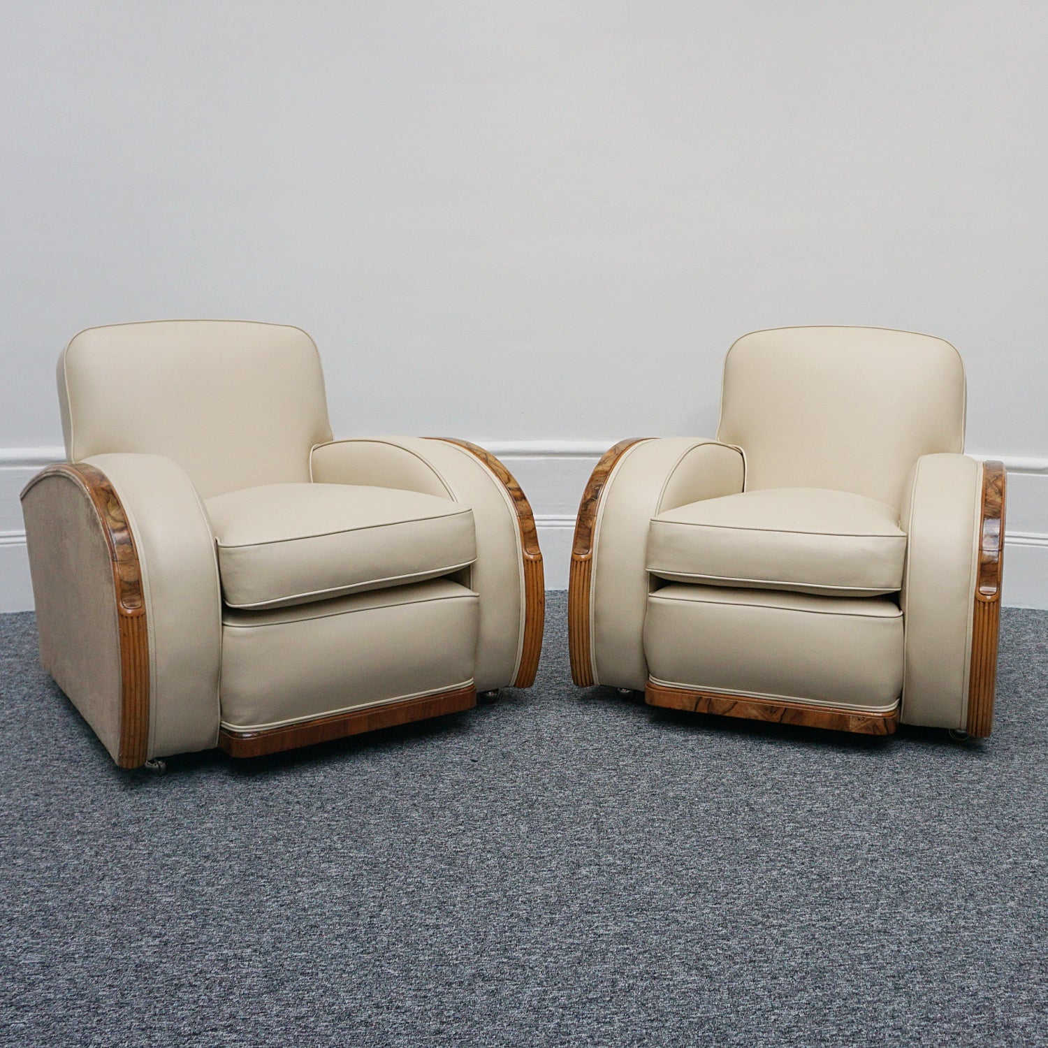 An Art Deco three piece tank suite by Heals of london. Made of Burr and solid walnut banding with reeded lower section, Upholstered in cream leather and contrasting faux suede