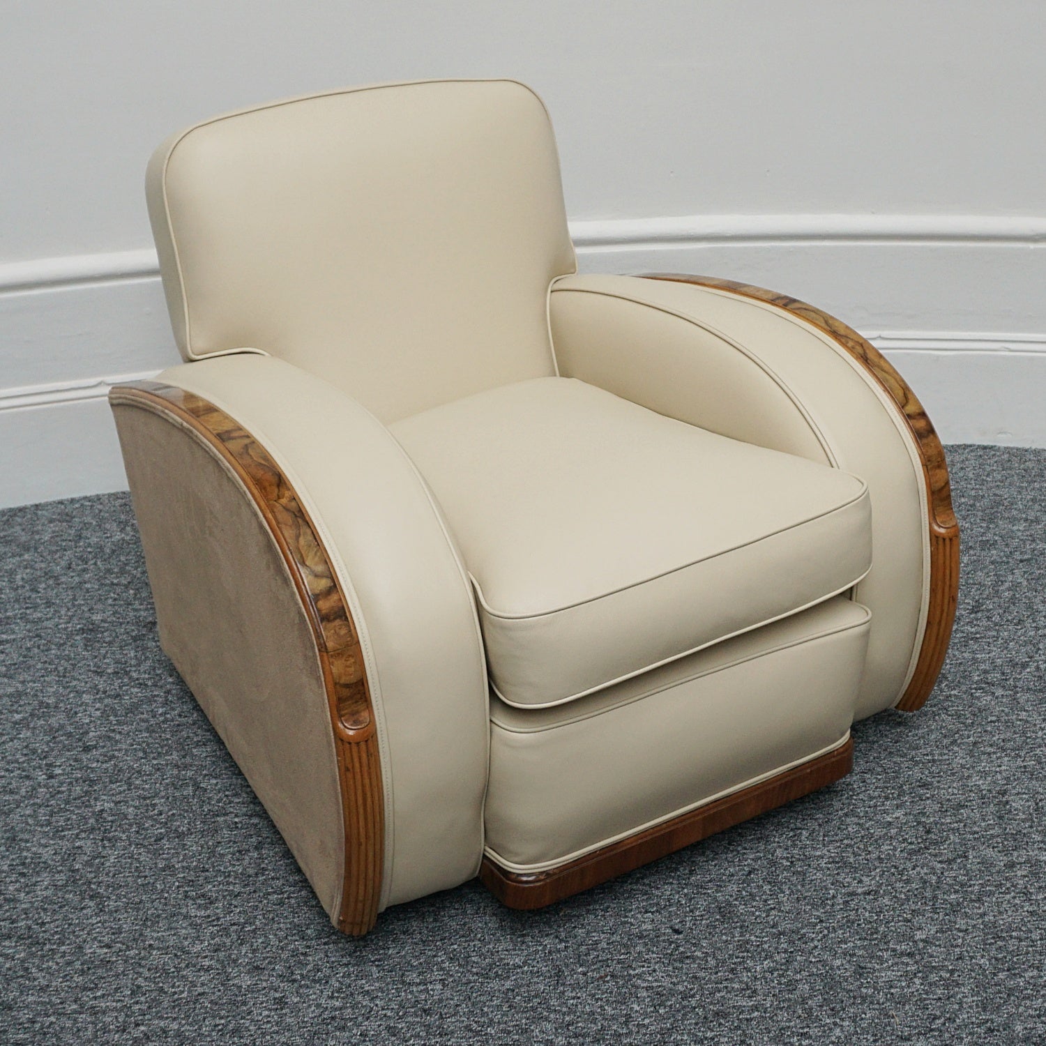 An Art Deco three piece tank suite by Heals of london. Made of Burr and solid walnut banding with reeded lower section, Upholstered in cream leather and contrasting faux suede