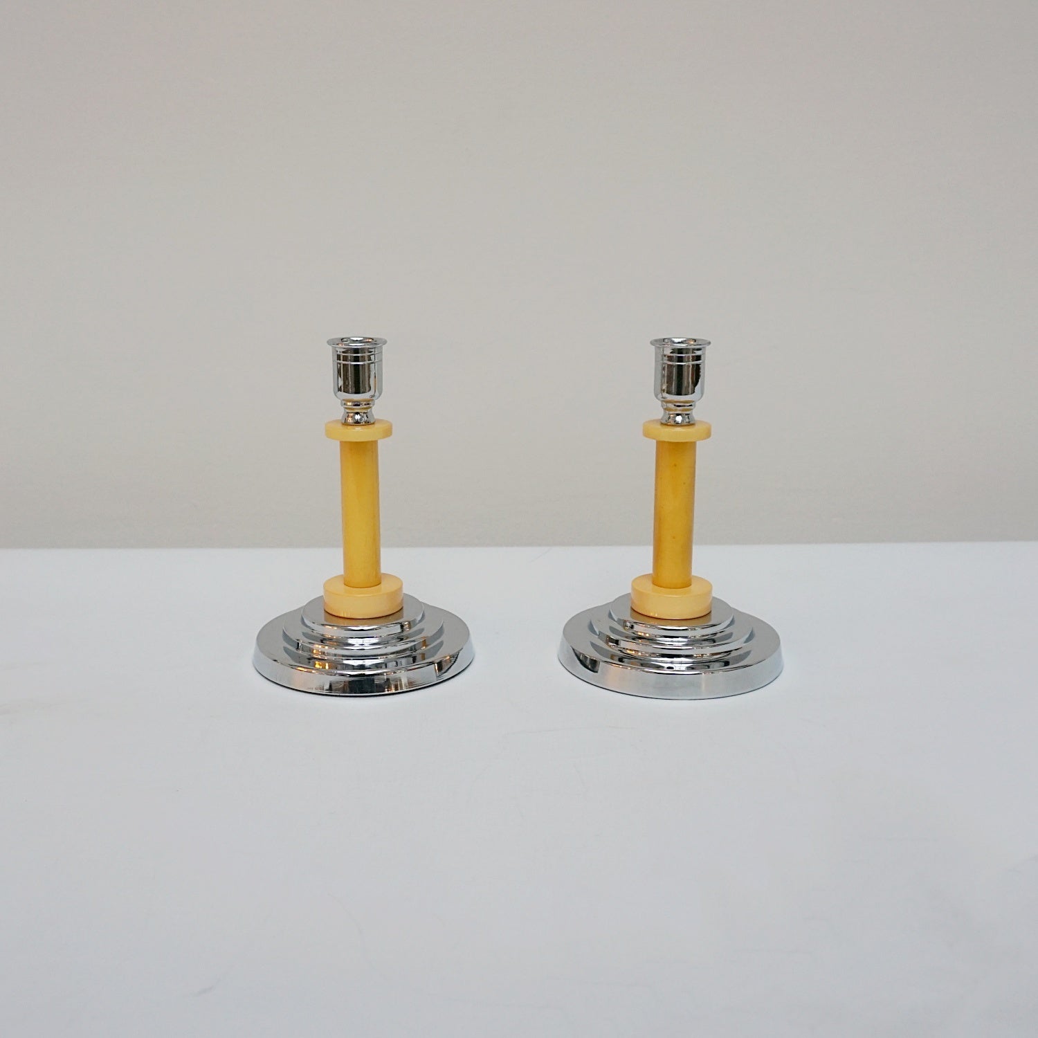 A pair of Art Deco candlesticks. Yellow bakelite stem with dual bakelite rings. Jeroen Markies Art Deco