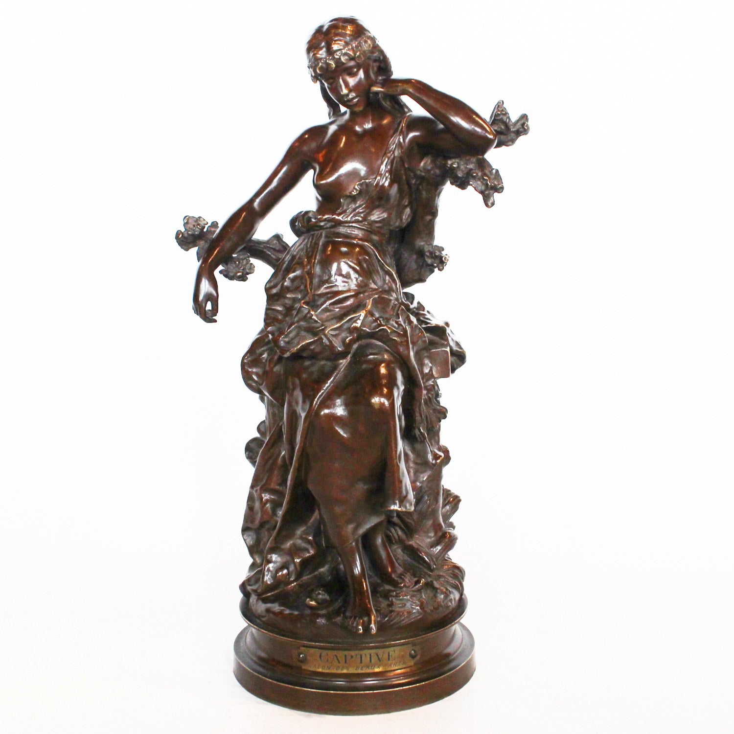 Captive, an Art Nouveau rich brown patinated bronze figure of a scantily clad young lady. Signed Hip Moreau to cast, and with title plaque to front at Jeroen Markies