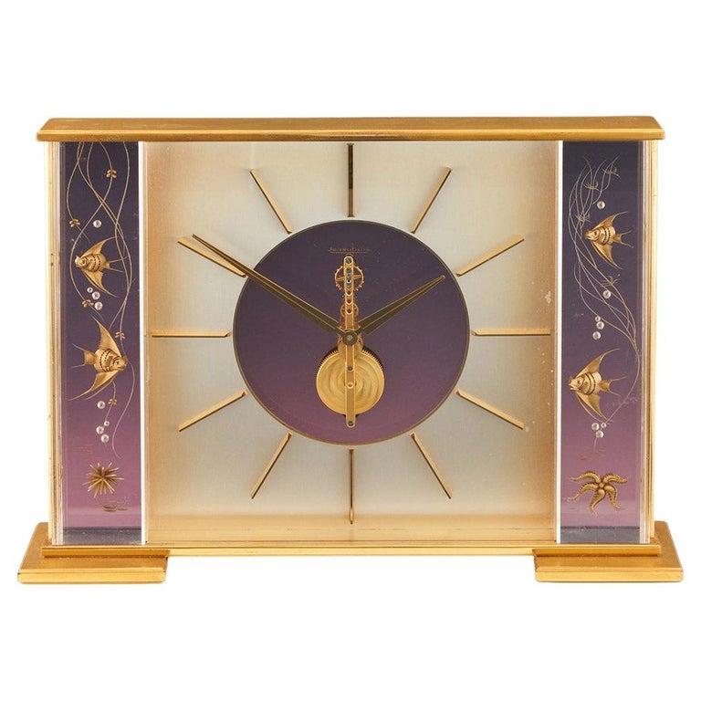 Mid century mantel clock by Jaeger-LeCoultre with brass fish decoration and a central square dial with a skeletonised 8 day movement