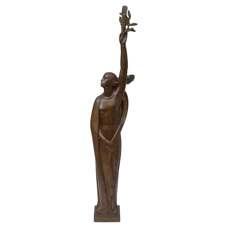 An Art Deco bronze sculpture of Ceres the Roman goddess of agriculture, fertility and motherly relationshios, holding alot a strand of wheat, bear breasted with a shawl around her and her hair flowing in the wind by André Bizette-Lindet 